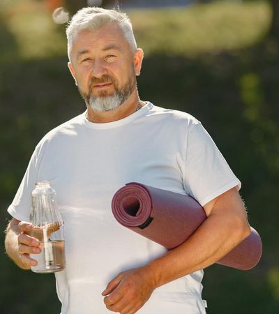 Rolled up yoga mat, a water bottle, and comfortable clothing.